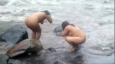 2992477 duo indian aged womens bathing in river bare