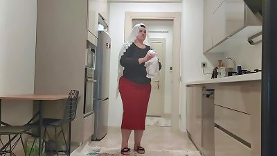 My stepson is watching me in the kitchen.