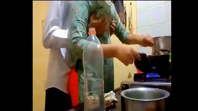 indian fresh married pair romance in kitchen.